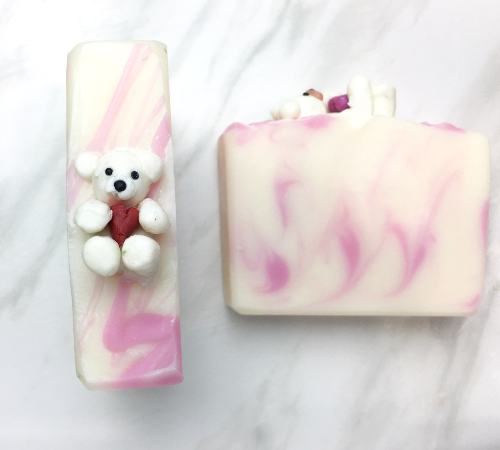 white and pink soap with white teddy bear soap as decoration